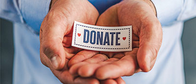 P2-Male-hands-donate-sign P2-Male-hands-donate-sign